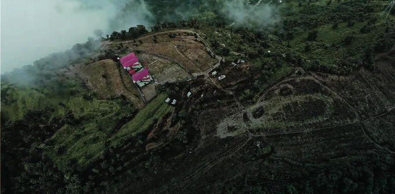 The site seen from above, held within the contours of the ridge. Aagar Hills, Rishikesh.