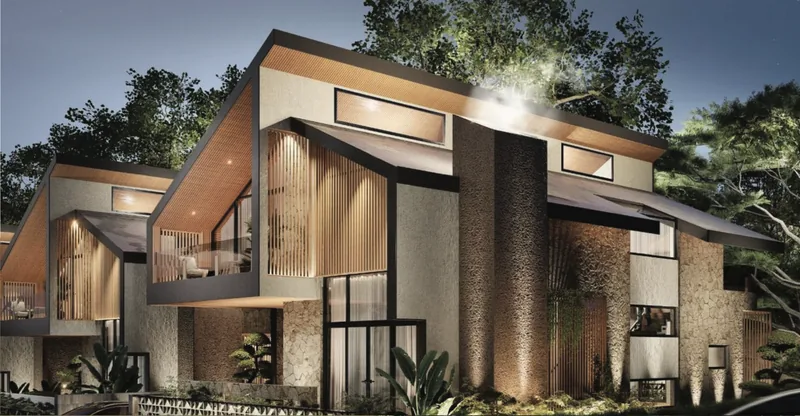 A residence at dusk — stone base, timber cladding and a pitched roof following the slope. Aagar Hills, Rishikesh.