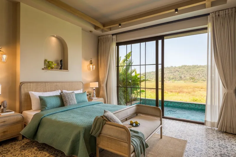 Bedroom opening to the valley view. Banyan Bliss, Guirim.
