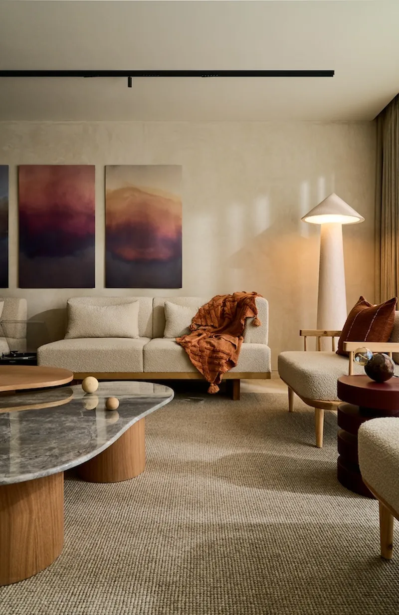 Indicative living-room styling: double-height volume with tall glazing