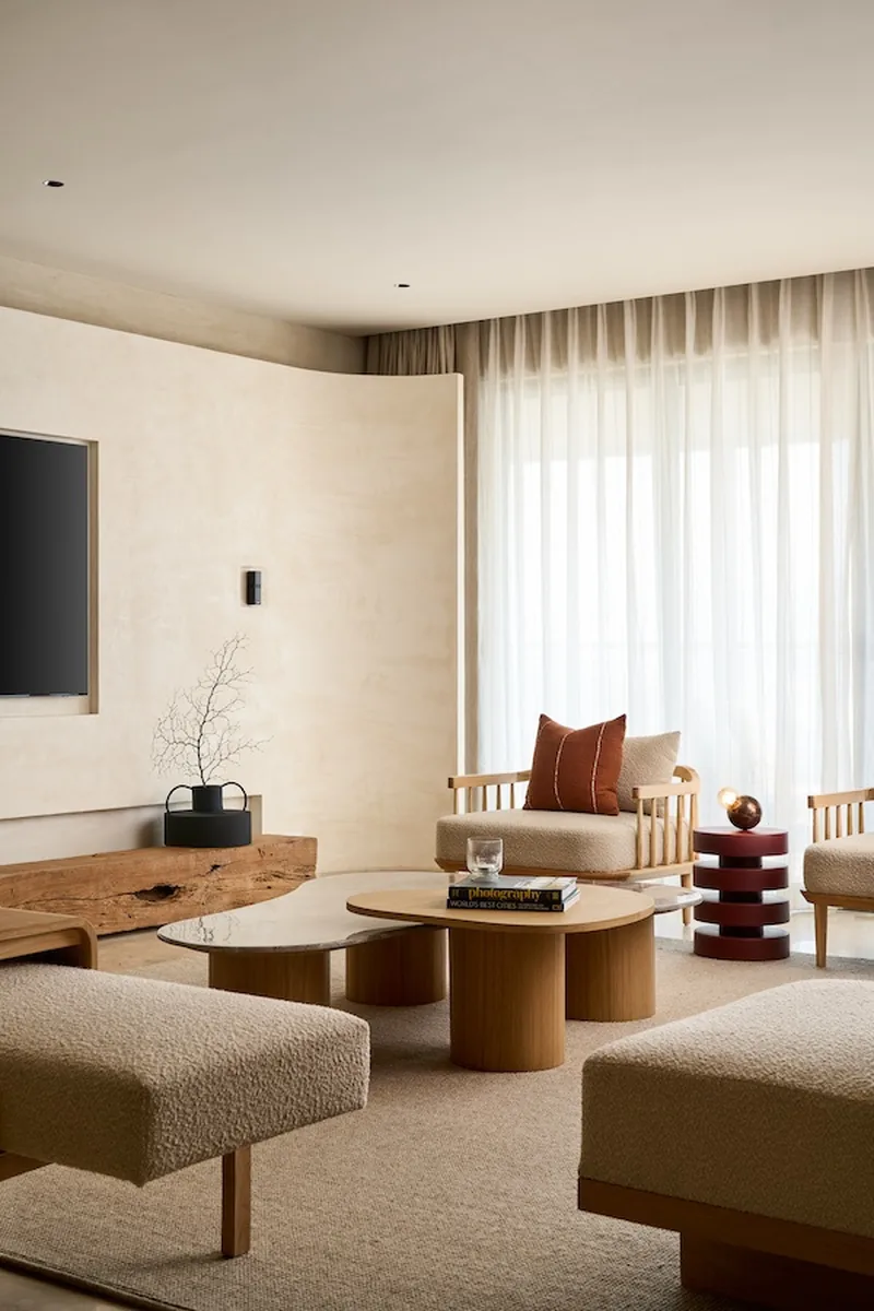 Indicative living-room styling: soft furnishings against a stone feature wall